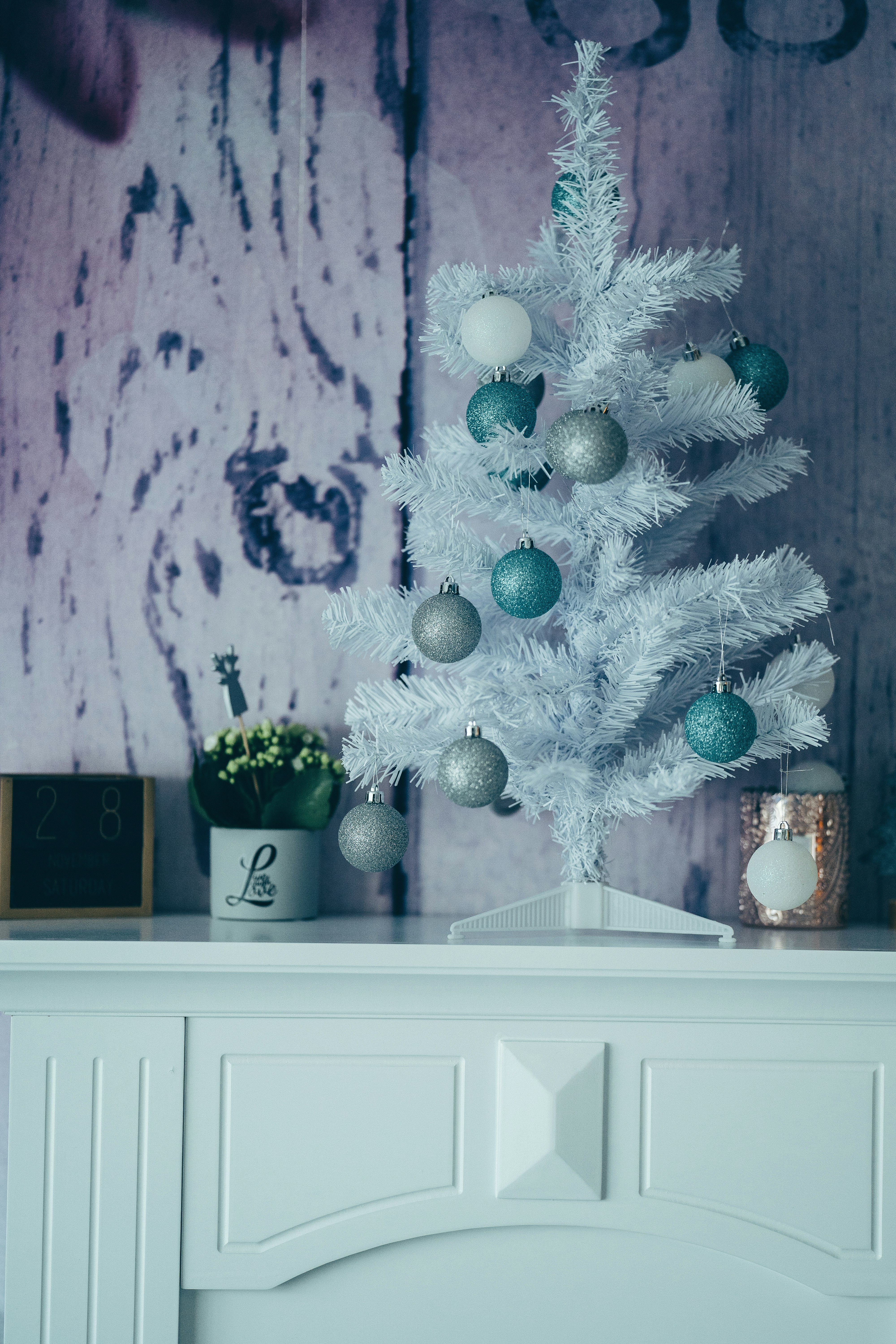 white and blue christmas tree on white wooden cabinet